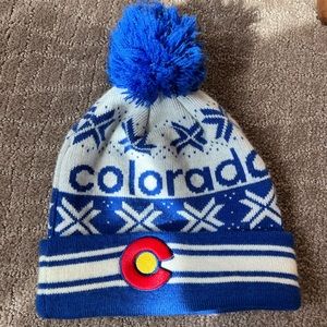 Colorado knitted beanie with a Pom Pom and hand stitched Colorado flag emblem